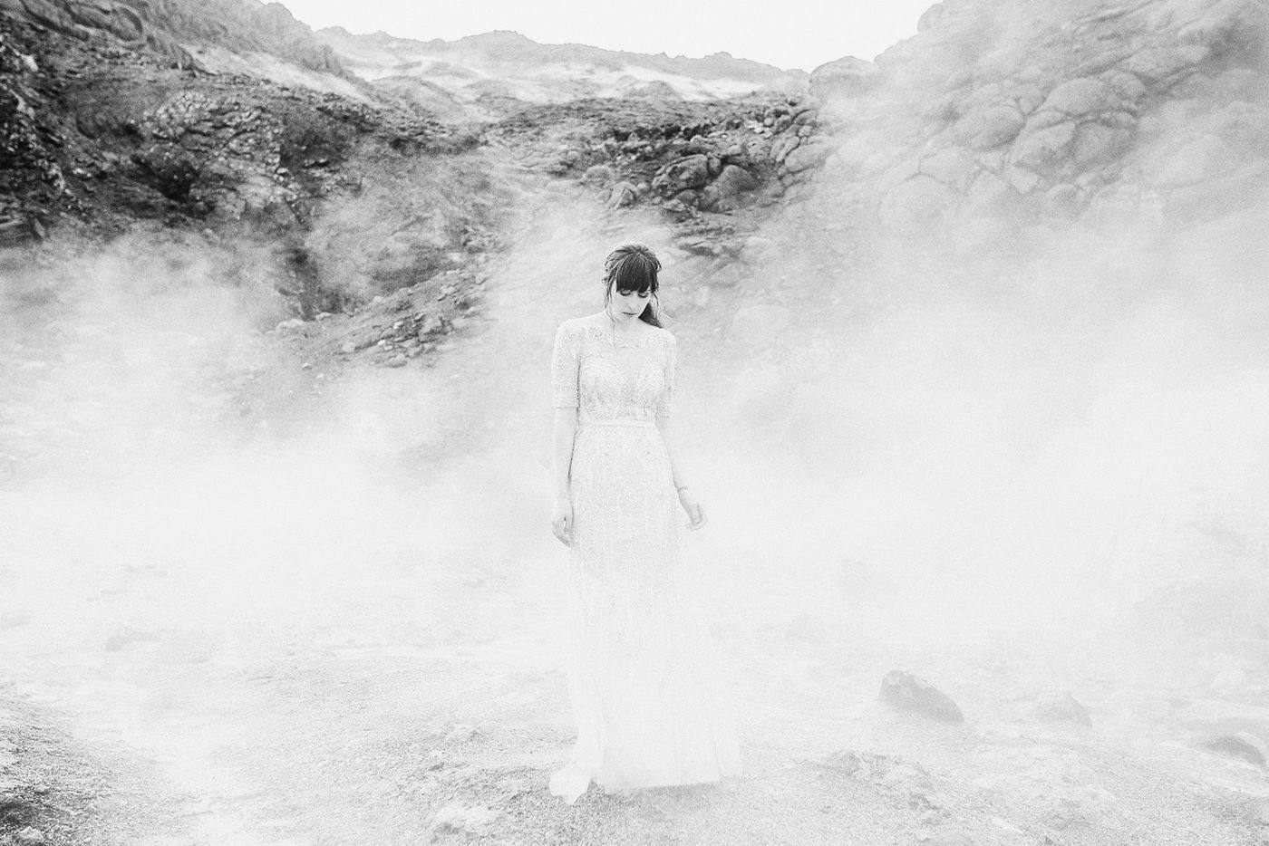 Bride emerging from geothermal mist