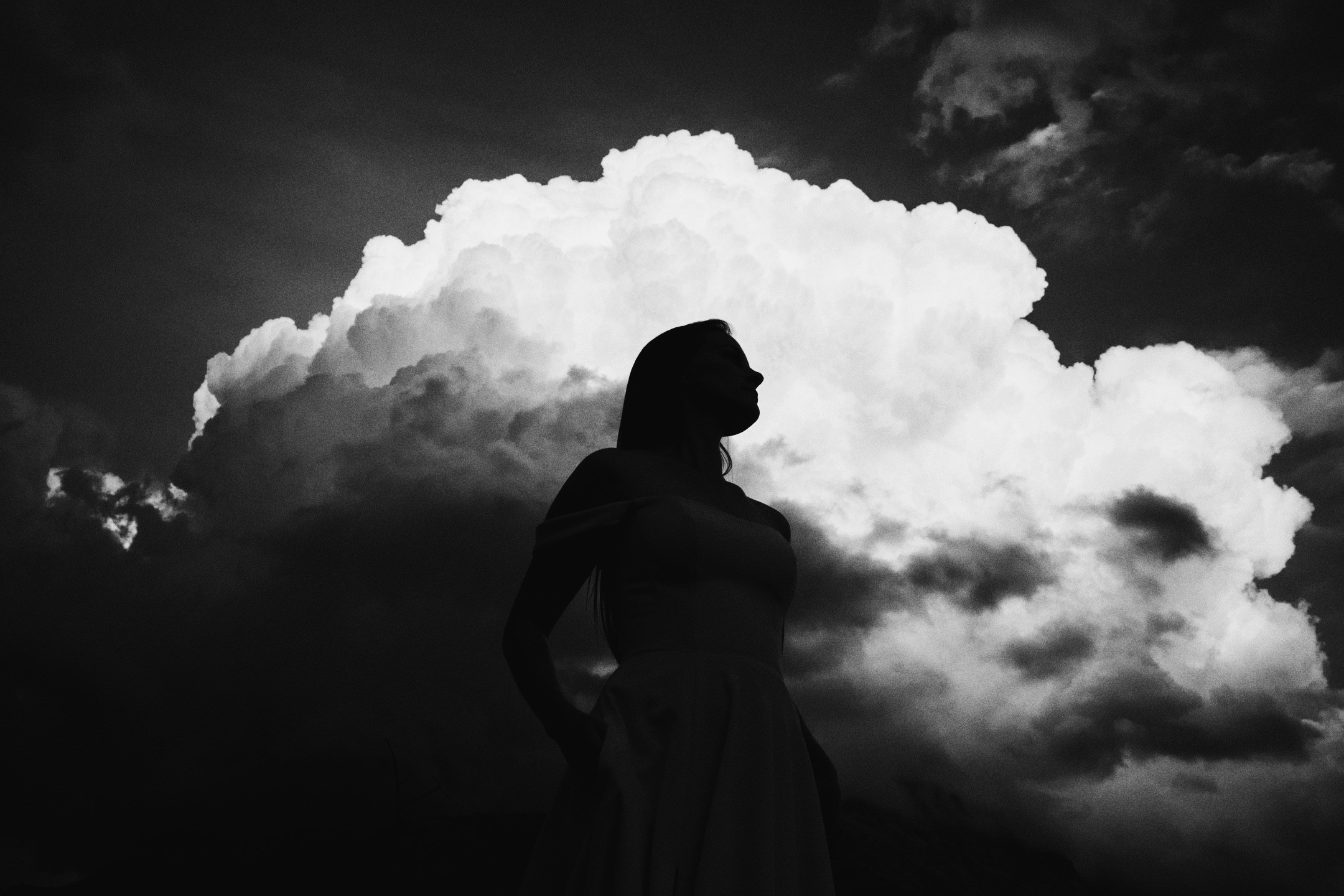 Photographer silhouetted against dramatic clouds